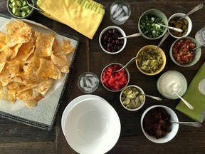 This undated photo provided by Katie Workman shows a nacho bar on a table inside a home in New York. (Katie Workman via AP) ORG XMIT: NYLS303