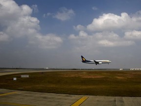 FILE- In this Dec. 25, 2017 file photo, a Jet Airways aircraft lands at the Kempegowda International Airport in Bangalore, India. India's Jet Airways says it has ordered an investigation into reports that a senior pilot slapped a female co-pilot in the cockpit during a London to Mumbai flight this week. (AP Photo/R S Iyer, File)