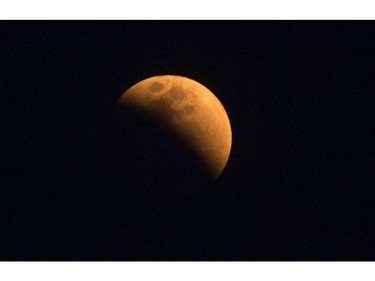 The moon turns a reddish hue as it passes through the earth's shadow during a lunar eclipse as seen in Gauhati, India, Wednesday, Jan. 31, 2018. (AP Photo/Anupam Nath)