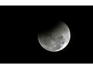The moon passes into the earth's shadow during a lunar eclipse as seen in Bangalore, India, Wednesday, Jan. 31, 2018. (AP Photo/Aijaz Rahi)
