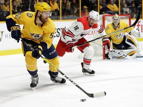 Nashville Predators defenceman Matt Irwin clears the puck away from Carolina Hurricanes centre Marcus Kruger during the first period of an NHL hockey game on Dec. 21, 2017