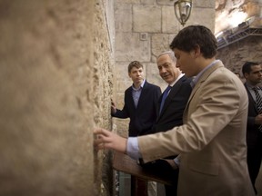 In this Jan. 22, 2013 file photo, Israeli Prime Minister Benjamin Netanyahu, centre, prays with his sons Yair, left, and Avner at the Western Wall, the holiest site where Jews can pray in Jerusalem's old city.