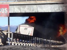 The back of a truck is seen as fire and black smoke engulf it after, according to reports, a tanker truck carrying inflammable liquid, which was ahead, went ablaze and caused the death of five passengers in a car and the driver of the truck behind it, along the A21 motorway between Brescia and Turin, in northern Italy, Tuesday, Jan. 2, 2018. (Filippo Venezia/ANSA via AP)