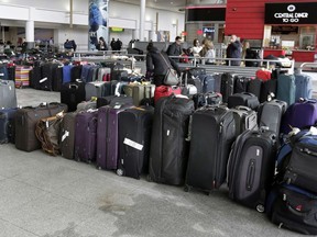FILE - In this Jan. 8, 2018, file photo, unclaimed baggage sits at New York's John F. Kennedy Airport after a water pipe burst following several days of weather-related delays in the wake of a powerful winter storm. Over a week after winter weather woes snowballed into a long weekend of dysfunction at the airport, some passengers are still waiting for their baggage. The still-missing luggage is a fraction of the thousands of unclaimed bags that accumulated during the chaos.