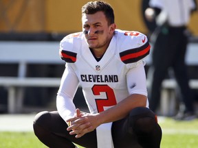 In this Nov. 15, 2015, file photo, Cleveland Browns quarterback Johnny Manziel looks on before an NFL football game against the Pittsburgh Steelers