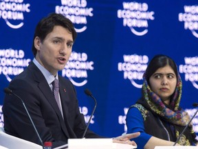 Prime Minister Justin Trudeau and Malala Yousafzai, co-founder of the Malala Fund,  participate in a panel discussion at the World Economic Forum in Davos, Switzerland on Thursday, Jan. 25, 2018.