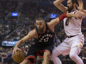 Toronto Raptors centre Jonas Valanciunas tries to get past Cleveland Cavaliers forward Kevin Love on Jan. 18, 2018