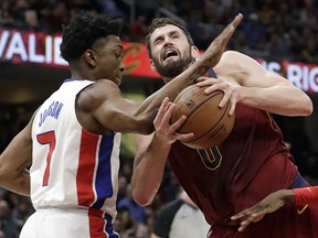 Detroit Pistons' Stanley Johnson, left, fouls Cleveland Cavaliers' Kevin Love in the first half of an NBA basketball game, Sunday, Jan. 28, 2018, in Cleveland. (AP Photo/Tony Dejak)