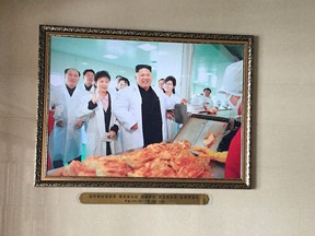 In this Dec. 20, 2017, photo, a portrait of North Korean leader Kim Jong Un is seen in the entrance way of the Ryugyong Kimchi Factory on the outskirts of Pyongyang, North Korea. (AP Photo/Eric Talmadge)