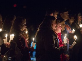 People attend a vigil at Mike Miller County Park in Benton, Ky., Thursday, Jan. 25, 2018. Hundreds of people turned out for the vigil that was held for the victims of the Marshall County High School shooting.