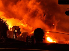 Fire from a train explosion is seen in Lac-Megantic, Que., on July 6, 2013 after a 74-car runaway freight train carrying crude oil derailed in the centre of the city. (Transportation Safety Board of Canada/HO)