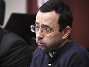 Larry Nassar looks at the gallery in the court during the sixth day of his sentencing hearing Tuesday, Jan. 23, 2018, in Lansing, Mich. (Dale G. Young/Detroit News via AP, File)
