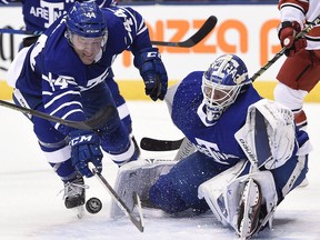 Maple Leafs goalie Frederik Andersen (31) makes a save against the Carolina Hurricanes as defenceman Morgan Rielly (44) tries to clear the puck in Toronto, Tuesday, December 19, 2017. (THE CANADIAN PRESS/Nathan Denette)