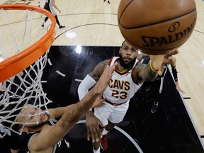 Cleveland Cavaliers forward LeBron James shoots past San Antonio Spurs forward Kyle Anderson during an NBA game on Jan. 23, 2018