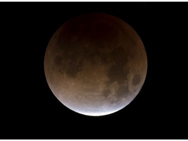 A partially eclipsed super blue blood moon is shown over the skies in Las Vegas, Wednesday, Jan. 31, 2018.  It's the first time in 35 years a blue moon has synced up with a supermoon and a total lunar eclipse. (Richard Brian/Las Vegas Review-Journal via AP)