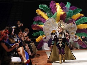 Jack Spittler III, a member of the royal court, walks for the audience at the Little Rascals Mardi Gras Ball in Kenner, La., Thursday, Jan. 25, 2018.