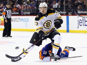 Charlie McAvoy of the Boston Bruins shoots the puck in against the New York Islanders at the Barclays Center on January 18, 2018. (Bruce Bennett/Getty Images)