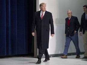 President Donald Trump, left, accompanied by Senate Majority Leader Mitch McConnell, second from right, and House Speaker Paul Ryan, right, arrives for a news conference after participating in a Congressional Republican Leadership Retreat at Camp David, Md., Saturday, Jan. 6, 2018.