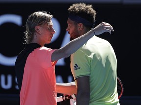 France's Jo-Wilfried Tsonga, right, is celebrated by Canada's Denis Shapovalov as he won their second round match at the Australian Open tennis championships in Melbourne, Australia, Wednesday, Jan. 17, 2018.