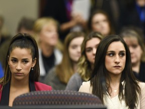 Former Olympians Aly Raisman, left, and Jordyn Wieber sit in Circuit Judge Rosemarie Aquilina's courtroom during the fourth day of sentencing for former sports doctor Larry Nassar, who pled guilty to multiple counts of sexual assault, Friday, Jan. 19, 2018, in Lansing, Mich.