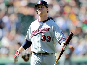 Justin Morneau of the Minnesota Twins reacts after striking out against the Oakland Athletics at the Oakland-Alameda County Coliseum on June 6, 2010 in Oakland.