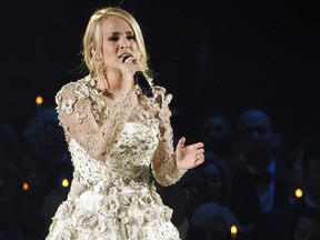 FILE - In this Wednesday, Nov. 8, 2017, file photo, Carrie Underwood performs "Softly and Tenderly" during an In Memoriam tribute at the 51st annual CMA Awards at the Bridgestone Arena in Nashville, Tenn. Underwood teamed up with Ludacris to co-write a new song "The Champion," which will be the opening video for the Super Bowl on Feb. 4 airing on NBC. The song, which was also written by country songwriters Brett James and Chris DeStefano, was released Friday, Jan. 12, 2018.