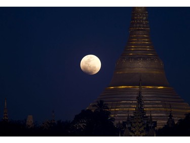 The moon rises behind Myanmar landmark Shwedagon pagoda, Wednesday, Jan.31, 2018, in Yangon, Myanmar.  (AP Photo/Thein Zaw)
