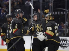 Vegas Golden Knights players celebrate their 2-1 victory over the New York Rangers following an NHL game Sunday, Jan. 7, 2018, in Las Vegas.