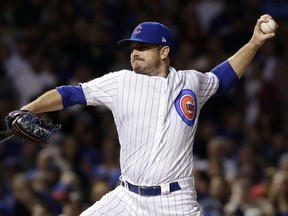 FILE - In this Oct. 18, 2017, file photo, Chicago Cubs relief pitcher Brian Duensing throws during the seventh inning of Game 4 of baseball's National League Championship Series against the Los Angeles Dodgers in Chicago. The Cubs bolstered their revamped bullpen on Wednesday, Jan. 17, 2018, bringing back Duensing with a $7 million, two-year contract.