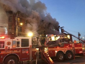 In this photo provided by the FDNY, firefighters battle a blaze at a building in the Bronx borough of New York, Tuesday, Jan. 2, 2018. (FDNY via AP)