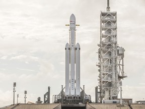 This Dec. 28, 2017 photo made available by SpaceX shows a Falcon Heavy rocket at Cape Canaveral, Fla. On Wednesday, Jan. 24, 2018, the rocket's three boosters -- 27 engines in all -- were tested. SpaceX is aiming for a February launch. (SpaceX via AP)