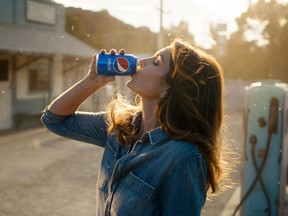 This photo released by Pepsi shows actress-model Cindy Crawford in a scene from her 2018 Pepsi commercial which will premiere during Super Bowl LII on Feb. 4. The new ad includes her son, Presley Walker Gerber, as well as footage from Michael Jackson's memorable Pepsi commercial. (Pepsi via AP)