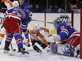 New York Rangers defenceman Kevin Shattenkirk (22) and Philadelphia Flyers left wing Taylor Leier (20) look for the rebound as New York Rangers goaltender Henrik Lundqvist (30) defends the goal during the first period of an NHL hockey game, Tuesday, Jan. 16, 2018, in New York.