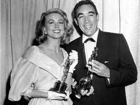 This March 27, 1957, file photo shows Best supporting Oscar winners Dorothy Malone and Anthony Quinn posing at the Academy Awards in Hollywood, Calif. (AP Photo)