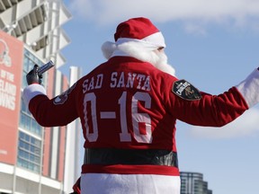 A Cleveland Browns fan dressed as Santa Claus participates in the 'Perfect Season' parade, Saturday, Jan. 6, 2018, in Cleveland.