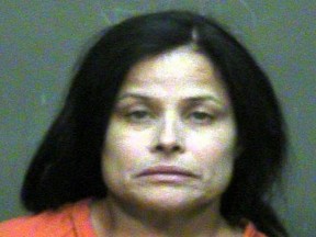 In this photo provided by the Oklahoma County Sheriff's Office, Juanita Gomez is pictured in a booking photo dated Aug. 28, 2016. Gomez is accused of killing her daughter by forcing a crucifix down her throat. (Oklahoma County Sheriff's Office via AP)