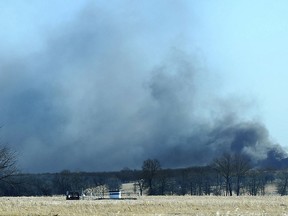 Smoke billows from the site of a gas well fire near Quinton, Okla., early Monday, Jan. 22, 2018.