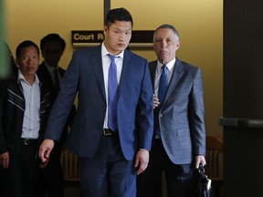 In this May 15, 2017, file photo, Raymond Lam, centre, leaves the Monroe County Courthouse in Stroudsburg, Pa. (AP Photo/Rich Schultz, File)