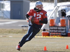 New England Patriots quarterback Tom Brady runs with the ball during practice on  Jan. 25, 2018, in Foxborough, Mass.