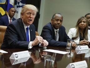 President Donald Trump speaks during a meeting on African American History Month in the Roosevelt Room of the White House in Washington, Wednesday, Feb. 1, 2017. From left are Trump, Housing and Urban Development Secretary-designate Ben Carson, and Lynne Patton. (AP Photo/Evan Vucci)