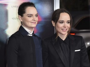 In this Sept. 27, 2017 file photo, Emma Portner, left, and Ellen Page arrive at the world premiere of "Flatliners" at The Theatre at Ace Hotel  in Los Angeles.  Page has married Portner, her publicist confirms.  Page, 30, first posted the news on Instagram Wednesday, Jan. 3, 2018,  with a photo of the couple's hands wearing wedding bands on their ring fingers.
