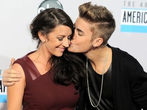 In this Nov. 18, 2012 file photo, Justin Bieber, right, kisses his mother Pattie Mallette at the 40th Anniversary American Music Awards in Los Angeles.