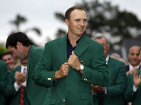 In this April 12, 2015, file photo, Jordan Spieth wears his green jacket after winning the Masters golf tournament in Augusta, Ga.  (AP Photo/David J. Phillip, File)