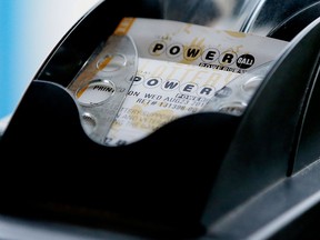 A Powerball lottery ticket is printed on a lottery machine at a convenience store in Dallas in a file photo.  (AP Photo/LM Otero)
