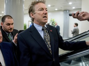 Sen. Rand Paul, R-Ky., speaks to reporters as he walks towards the Senate as Congress moves closer to the funding deadline to avoid a government shutdown on Capitol Hill in Washington, Thursday, Jan. 18, 2018.