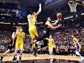 Toronto Raptors guard Fred VanVleet shoots while falling as Los Angeles Lakers guard Jordan Clarkson defends during first half NBA basketball action in Toronto on Sunday, Jan. 28, 2018. THE CANADIAN PRESS/Frank Gunn