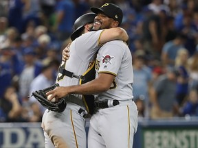 Francisco Cervelli of the Pittsburgh Pirates celebrates with closer Felipe Rivero during MLB action against the Toronto Blue Jays at Rogers Centre on August 11, 2017 in Toronto. (Tom Szczerbowski/Getty Images)