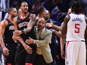 Trevor Ariza of the Houston Rockets is restrained by an assistant coach before his ejection from the game during a 113-102 LA Clippers win at Staples Center on January 15, 2018 in Los Angeles. (Harry How/Getty Images)