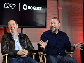 Vice co-founder and CEO Shane Smith (right) gestures as Rogers Communications President and CEO Guy Laurence laughs during an announcement in Toronto on Thursday October 30, 2014.