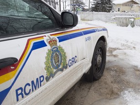 In this file photo, an RCMP cruiser is seen outside a home in La Loche, Sask. on Monday, Jan. 25, 2016.